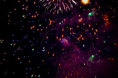 Low angle view of firework display at night