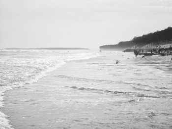 View of calm beach against clear sky