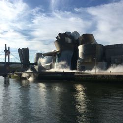 Built structure in sea against cloudy sky