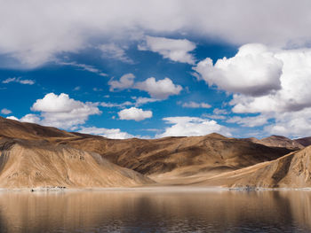 Scenic view of lake against cloudy sky