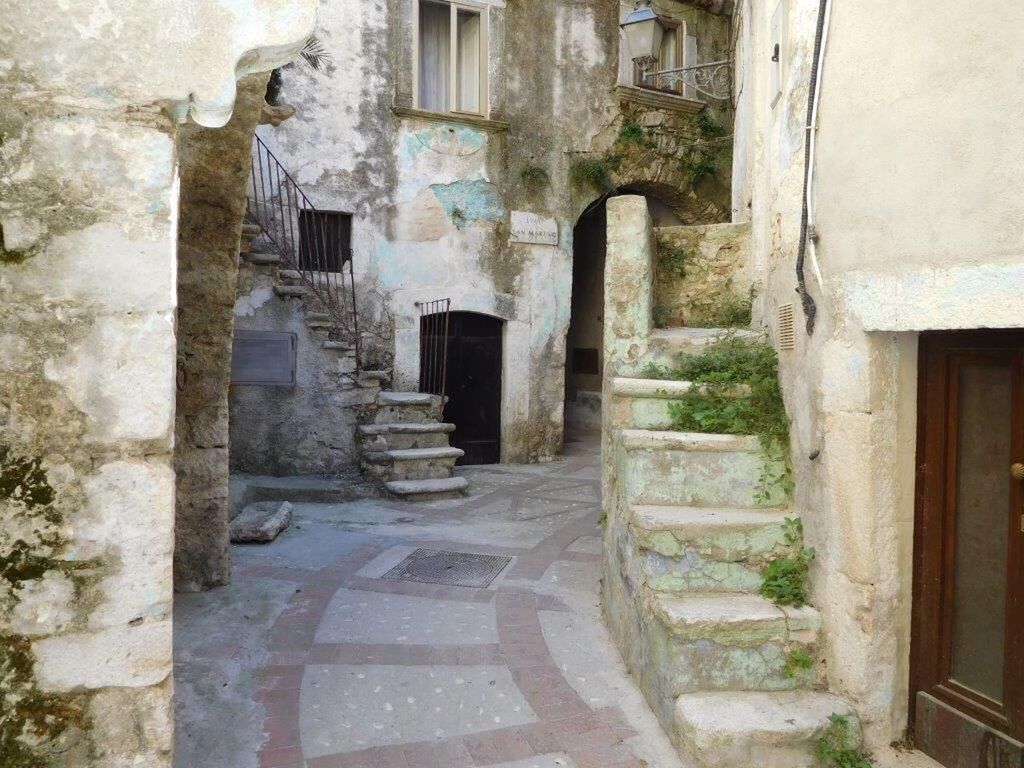 architecture, built structure, building exterior, the way forward, wall - building feature, building, old, steps, narrow, wall, stone wall, history, window, brick wall, house, day, residential building, residential structure, weathered, alley