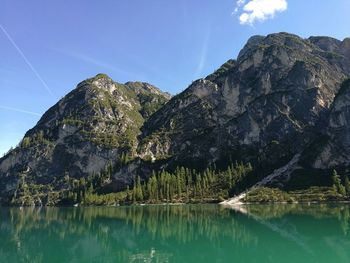 Scenic view of lake and mountains against blue sky