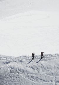 Aerial view of people skiing on snowcapped mountain