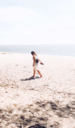 Full length of man on beach against sky