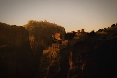 Scenic view of mountains against clear sky during sunset