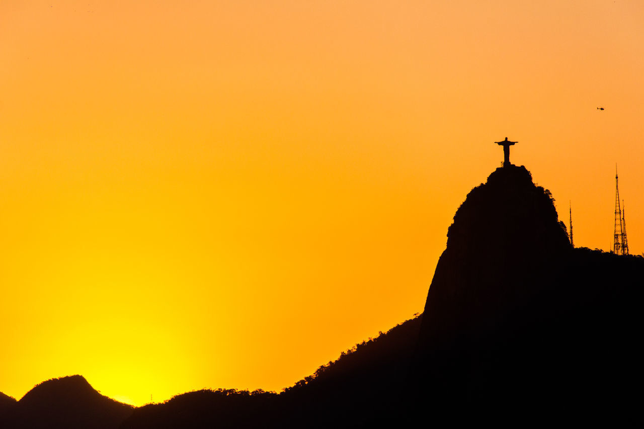 SILHOUETTE OF STATUE AT SUNSET