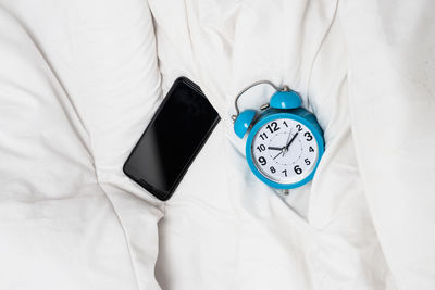 High angle view of clock on bed at home