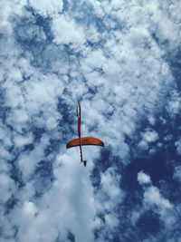 Low angle view of helicopter flying against sky