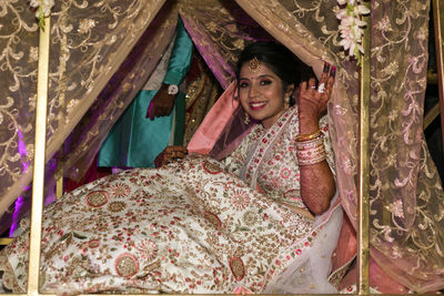 Portrait of a smiling young woman on bed