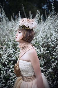 Rear view of woman with flowers on tree