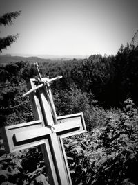 Cross on landscape against clear sky