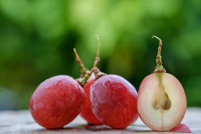 Close-up of red grapes on table outdoors