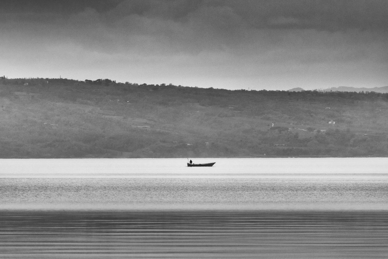 BOAT ON SEA AGAINST SKY