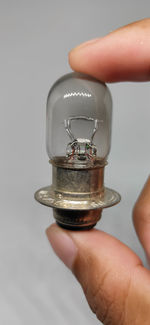 Close-up of hand holding glass over white background