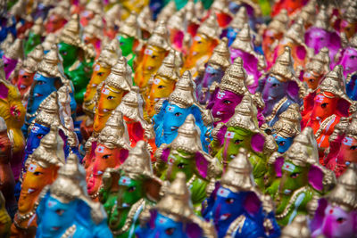 Close-up of colorful ganesha idols for sale at market