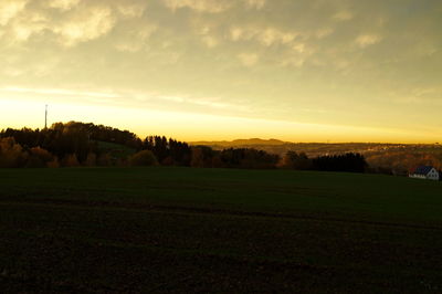 Scenic view of field against sky during sunset
