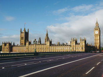 Buildings in city against cloudy sky