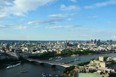 Aerial view of city against cloudy sky