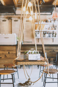 Succulents plants in metal box on hanging table as ornate of cafe interior.