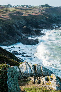 Scenic view of sea shore with splashing waves in the storm.