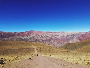 Scenic view of mountains against clear blue sky