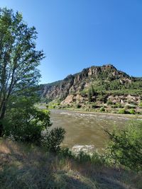 Scenic view of landscape against clear blue sky