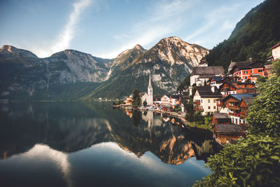 Panoramic view of lake and buildings against sky