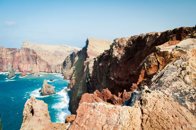 Scenic view of sea and mountains against sky