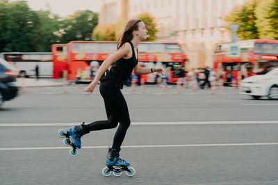 Full length of man skateboarding on road