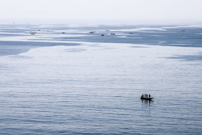 People in boat on sea