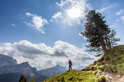 Man standing on mountain against sky