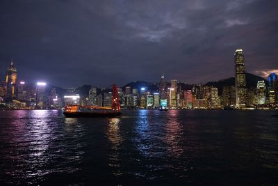 Illuminated city at waterfront