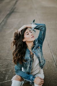 Portrait of young woman sitting outdoors