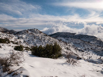 Scenic view of snow covered mountains against sky