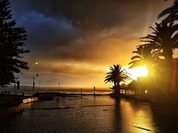 Scenic view of sea against cloudy sky at sunset