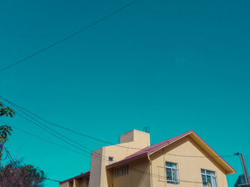 Low angle view of buildings against clear blue sky