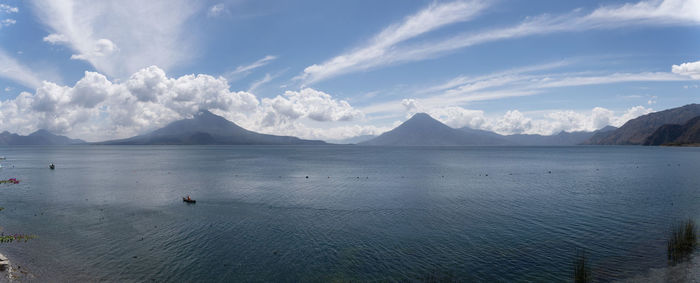 Panoramic view of sea and mountains against sky