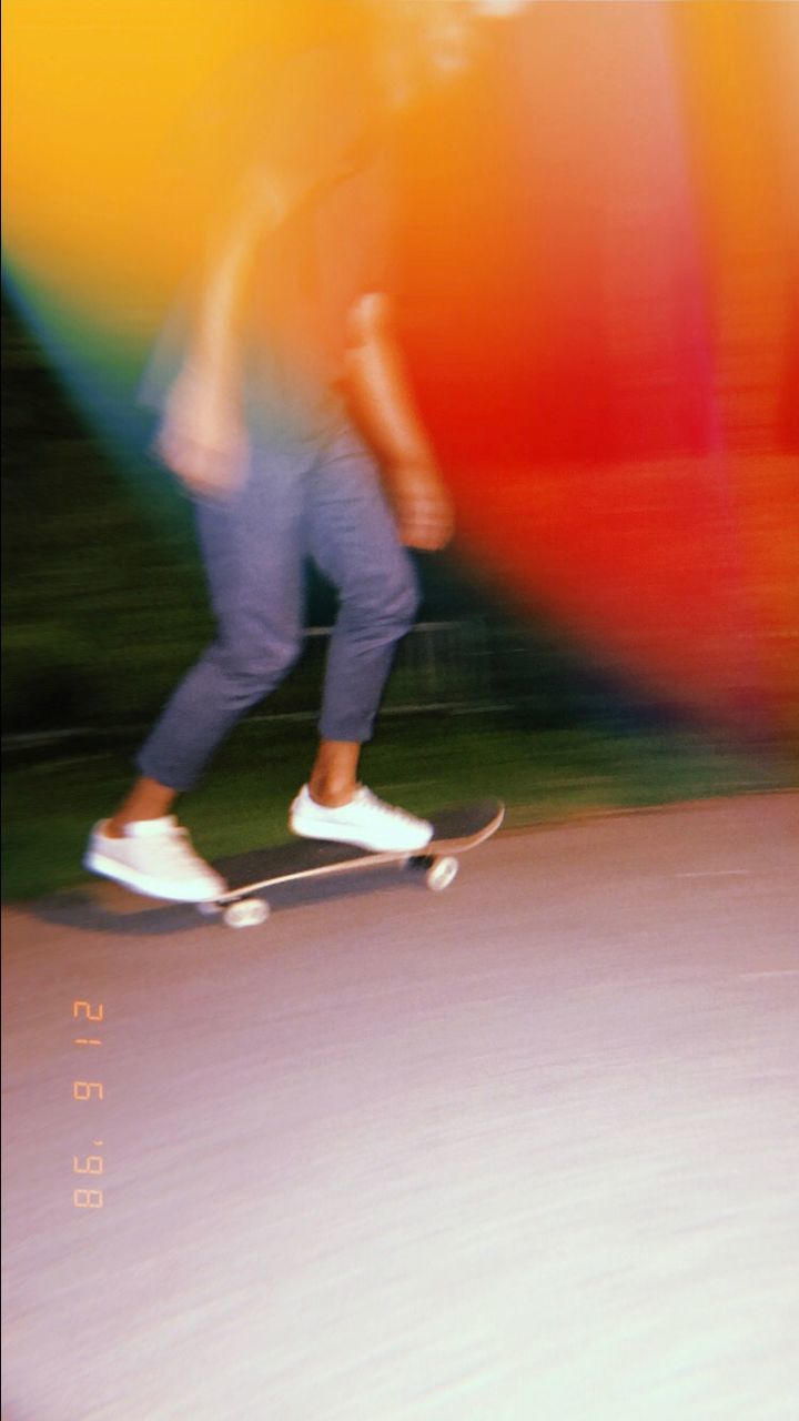 LOW SECTION OF MAN RUNNING ON BLURRED BACKGROUND