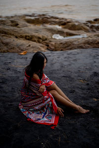 Woman sitting on beach