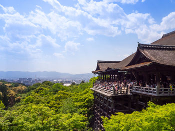 Temple by building against sky