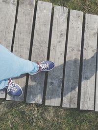 Low section of woman standing on wood
