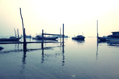 View of boats in sea at sunset