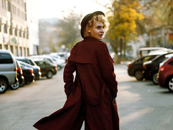 Portrait of young woman standing on street