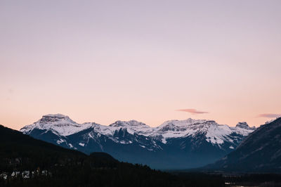 Scenic view of snowcapped mountains against sky during sunset