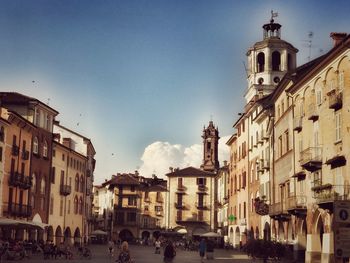 Panoramic view of people in city against sky