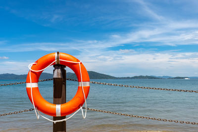 View of wooden post in sea against sky