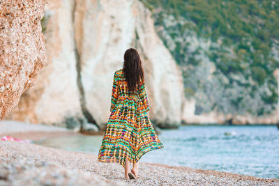 Rear view of woman standing in water