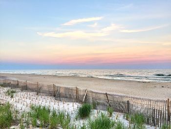 Scenic view of beach against sky during sunset