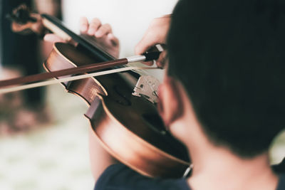 Midsection of man playing guitar