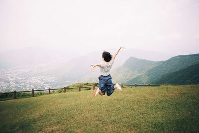 Full length of woman standing on grassy landscape